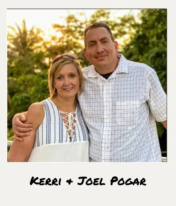 A woman and a man stand close together outdoors, smiling at the camera. The man has his arm around the woman. Trees and greenery are in the background. The names "Kerri + Joel Pogar" are written below the image.